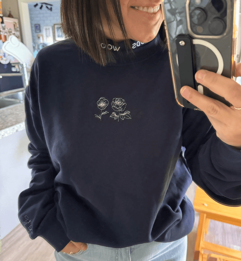 alt tag: Adults collection home decor featuring a stylish navy sweatshirt with floral embroidery.