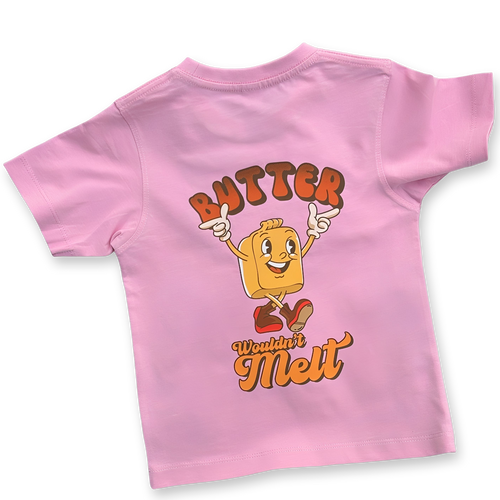 Back of pink kids' t-shirt featuring a large cartoon butter character with red boots and the playful phrase "Butter Wouldn't Melt" in bold retro lettering.